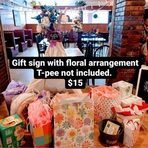 Gift sign with floral arrangement.